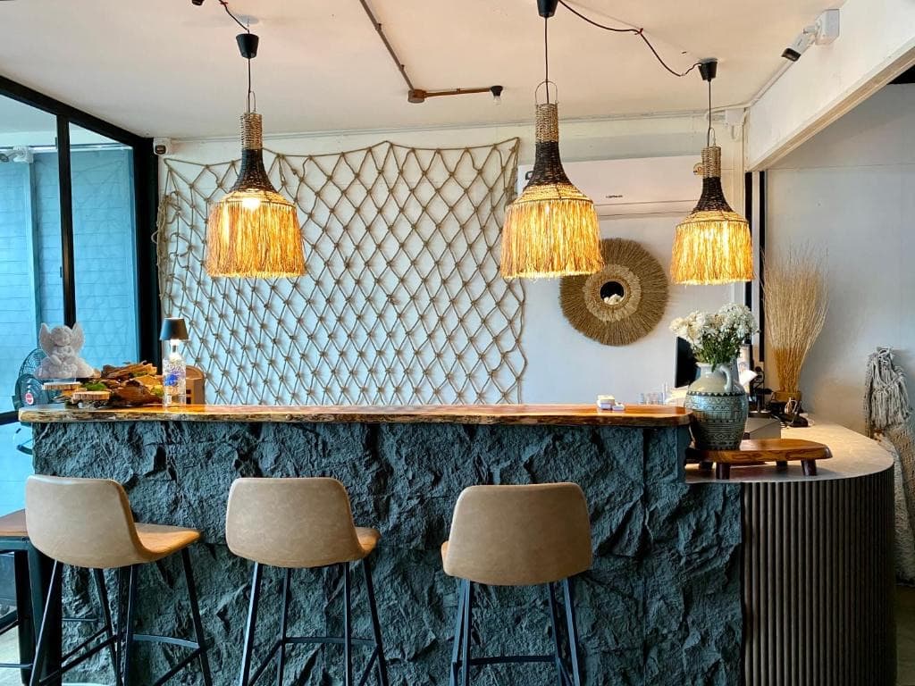 Riverside bar at Bud Brew Kanchanaburi with stone counter and rattan lights